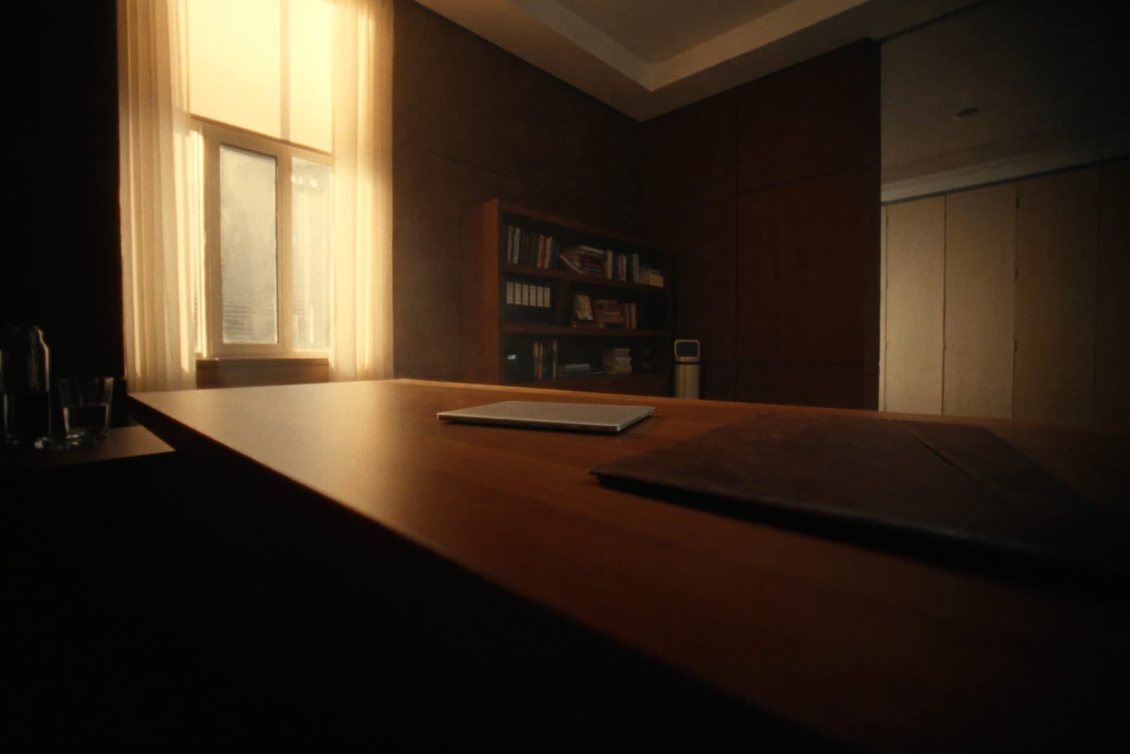 Quiet consulting firm boardroom corner with a long oak table and warm morning light